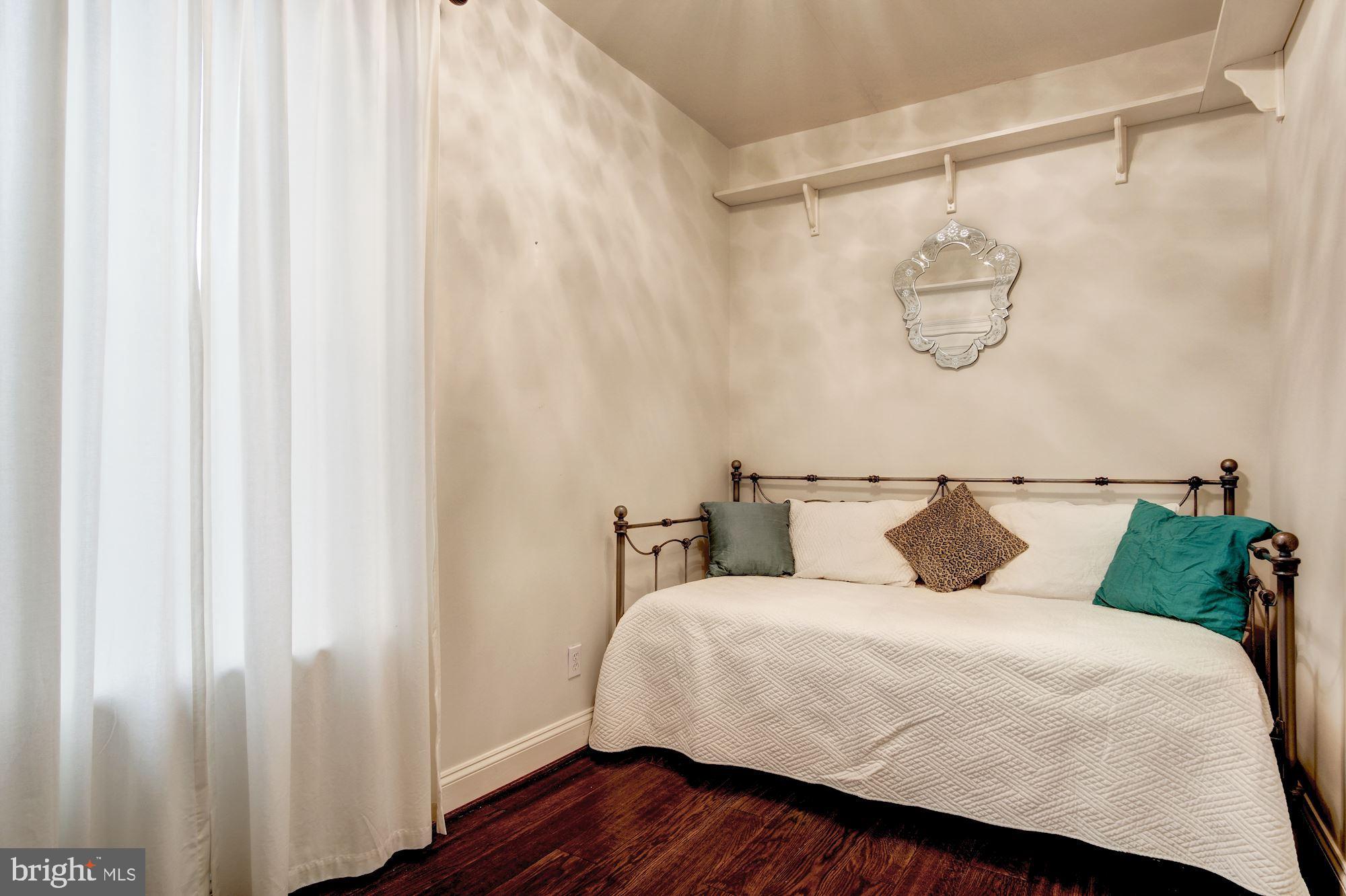 3040 R Street Northwest, Unit 1/2 Washington, DC 20007 - Photo 15 of 33 a bedroom with a bed and a mirror on the wall