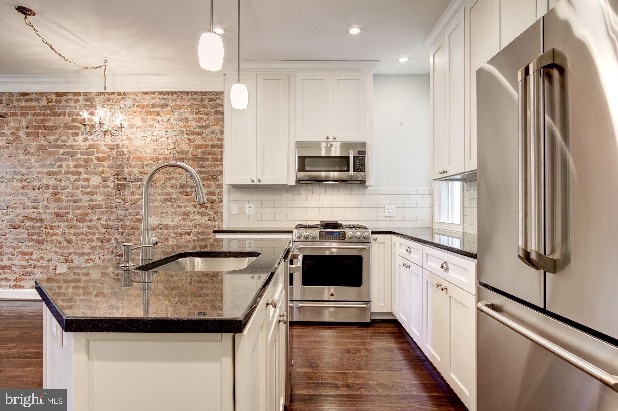 3040 R Street Northwest, Unit 1/2 Washington, DC 20007 - Photo 19 of 33 a kitchen with stainless steel appliances granite countertop a sink stove and refrigerator