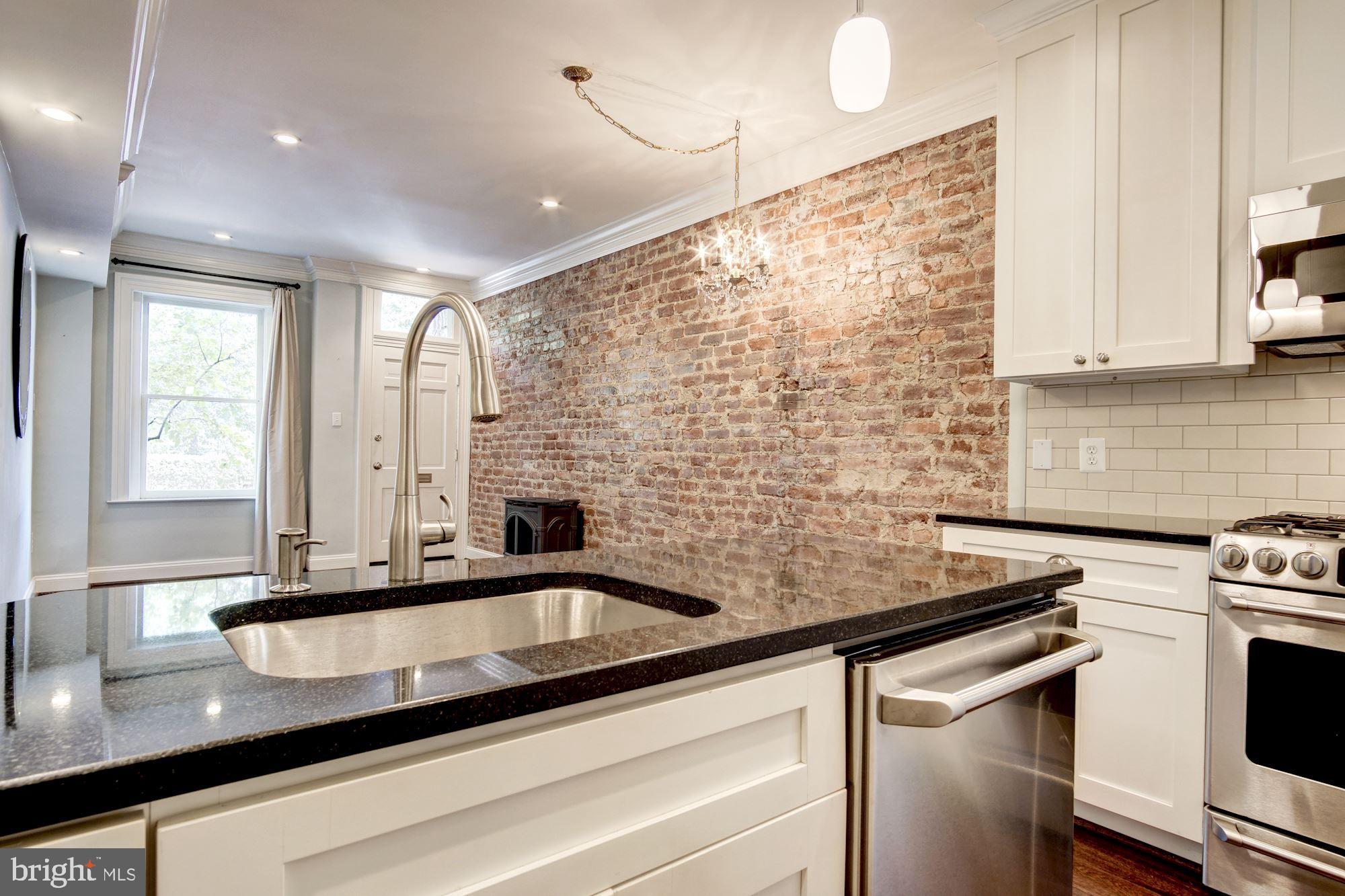 3040 R Street Northwest, Unit 1/2 Washington, DC 20007 - Photo 20 of 33 a kitchen with stainless steel appliances a sink a stove and a counter top space