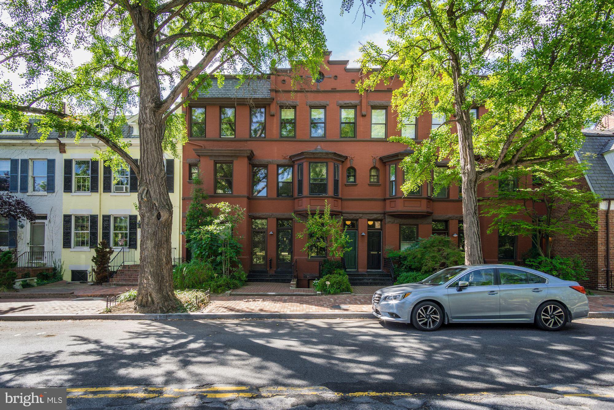 3040 R Street Northwest, Unit 1/2 Washington, DC 20007 - Photo 2 of 33 a view of a car parked in front of a brick house
