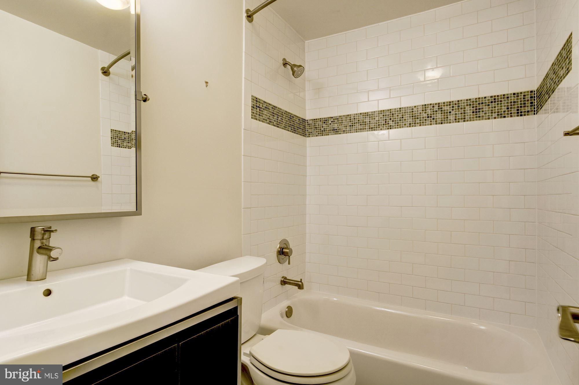 3040 R Street Northwest, Unit 1/2 Washington, DC 20007 - Photo 25 of 33 a bathroom with a sink a toilet and shower