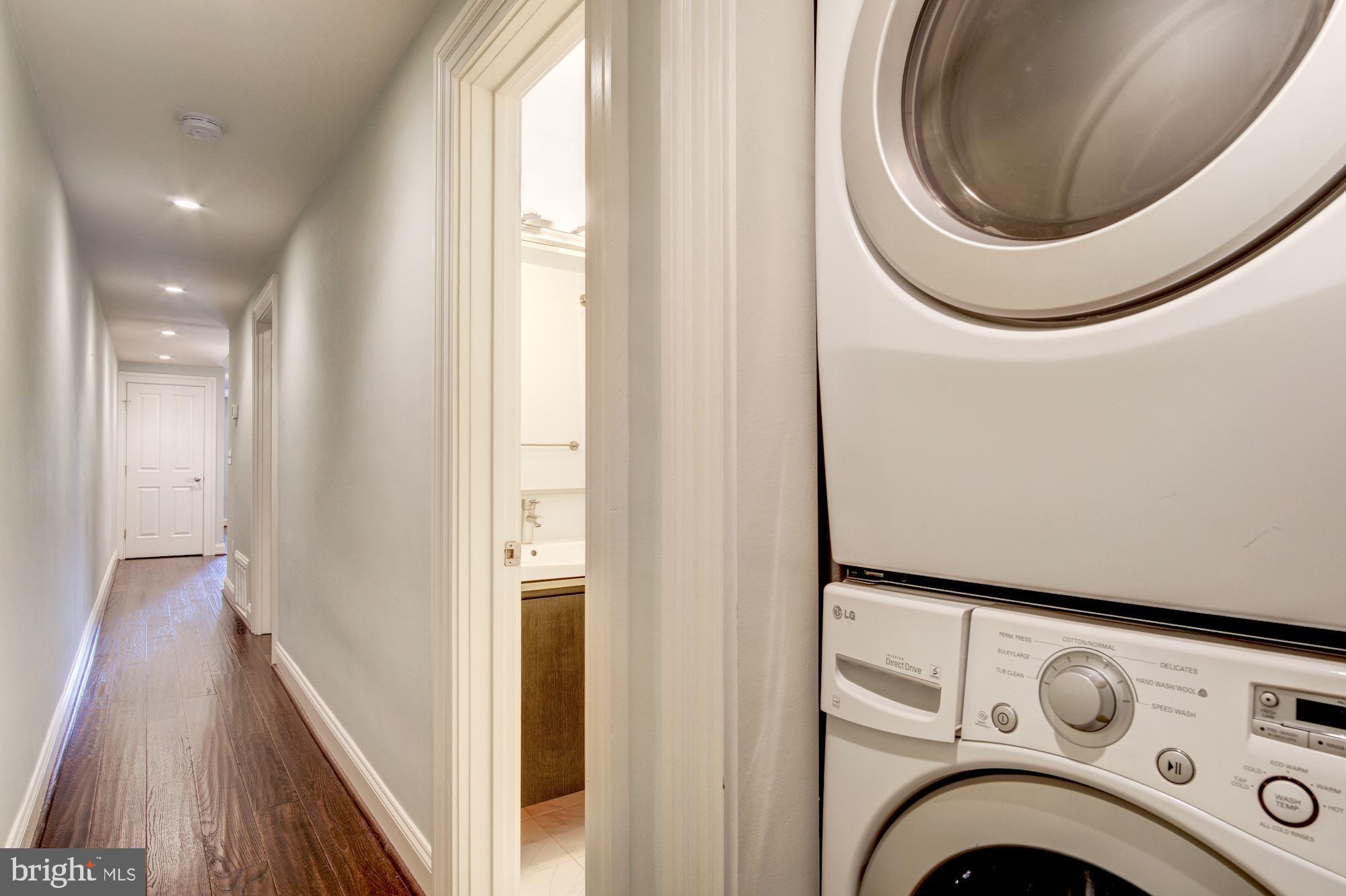 3040 R Street Northwest, Unit 1/2 Washington, DC 20007 - Photo 26 of 33 a view of a hallway with washer and dryer