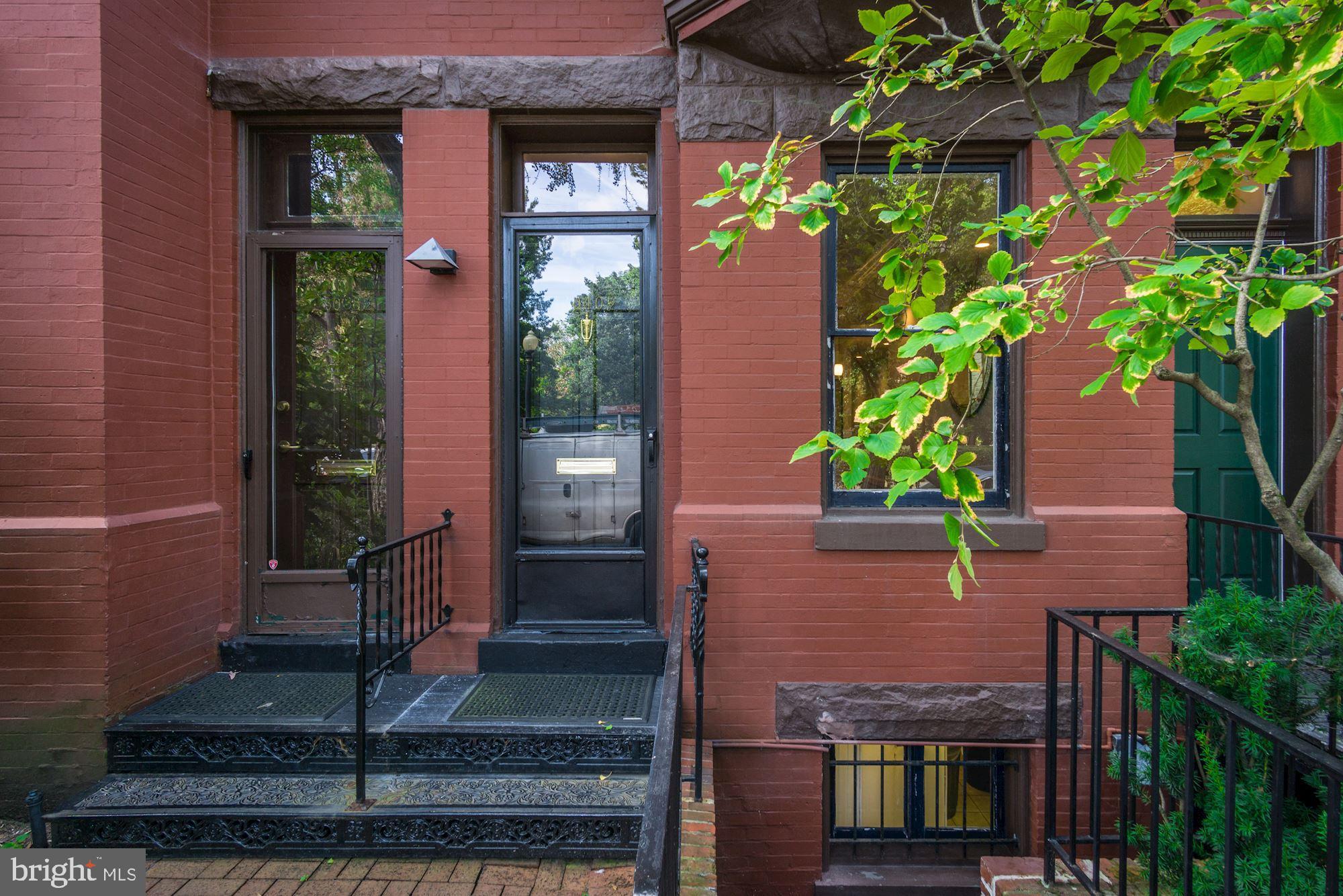 3040 R Street Northwest, Unit 1/2 Washington, DC 20007 - Photo 3 of 33 a front view of a house with a yard