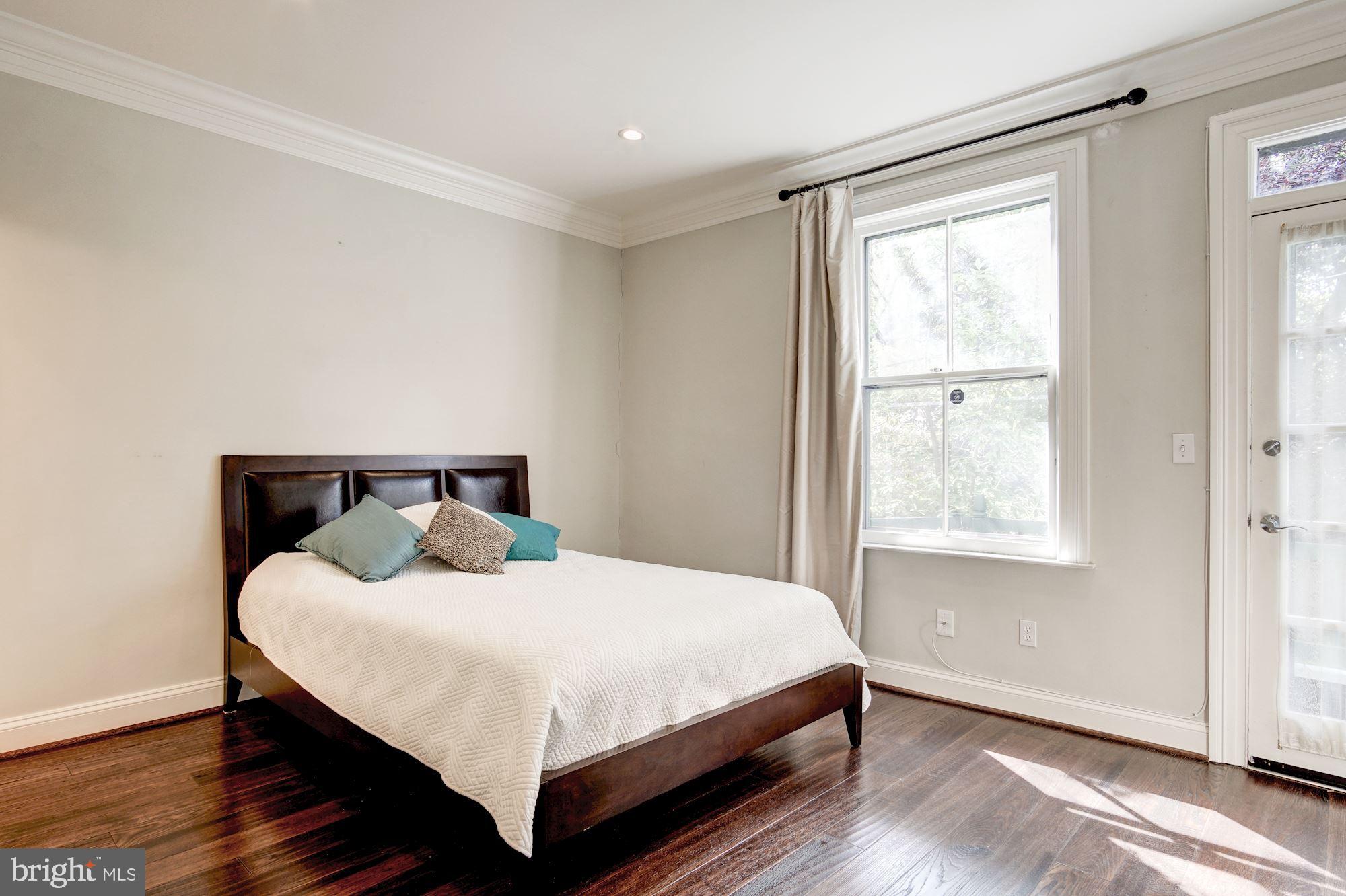 3040 R Street Northwest, Unit 1/2 Washington, DC 20007 - Photo 10 of 33 a bedroom with a bed and window