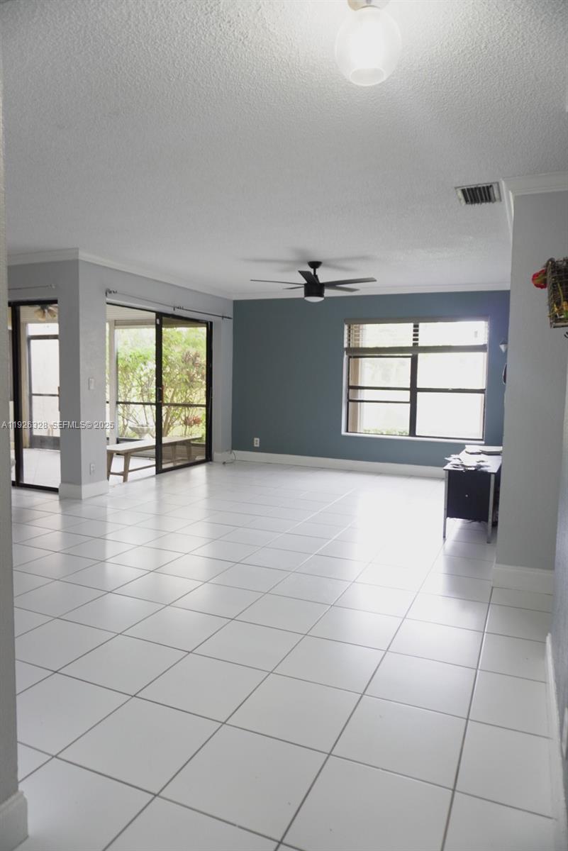3350 Northwest 47th Avenue, Unit 3273 Coconut Creek, FL 33063 - Photo 2 of 11 a view of an empty room and window