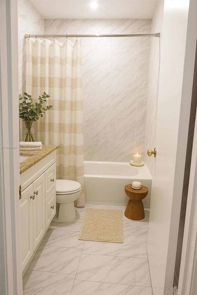 3350 Northwest 47th Avenue, Unit 3273 Coconut Creek, FL 33063 - Photo 6 of 11 a bathroom with a toilet a sink and a shower