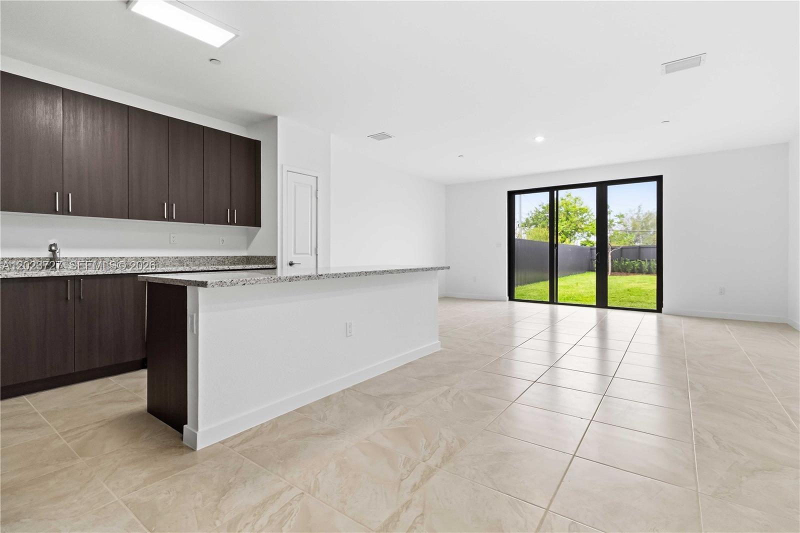 22348 Southwest 115th Court, Unit 22348 Miami, FL 33170 - Photo 2 of 37 a view of a kitchen with a sink and a window