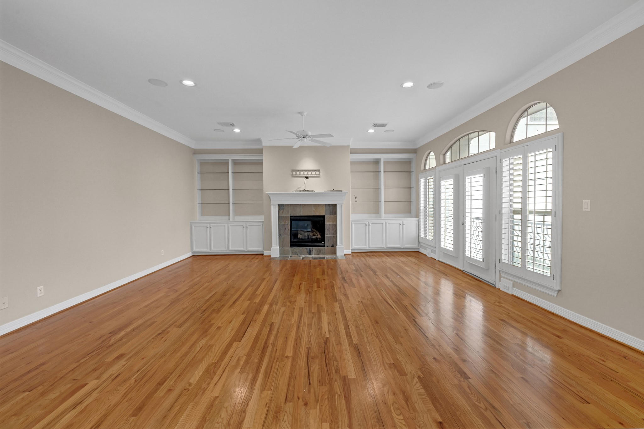 1204 Cohn Street Houston, TX 77007 - Photo 12 of 25 wooden floor fireplace and windows in an empty room