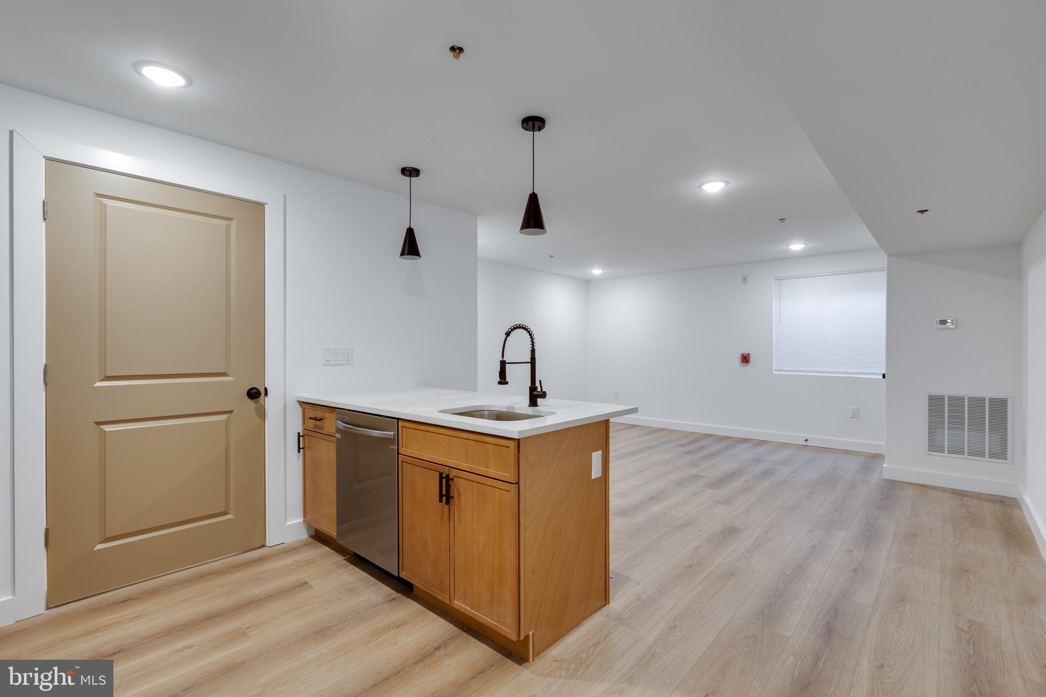 2203 North 7th Street, Unit 2 Philadelphia, PA 19133 - Photo 2 of 12 a view of a kitchen with a sink and wooden floor