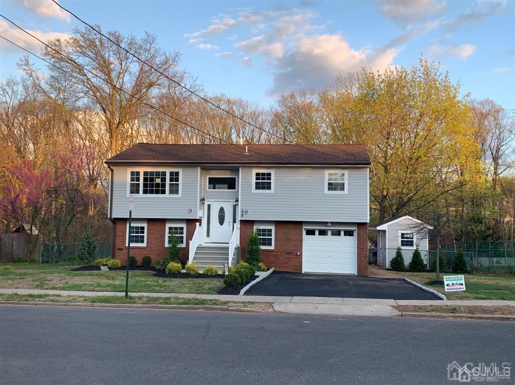 a view of street along with house and trees