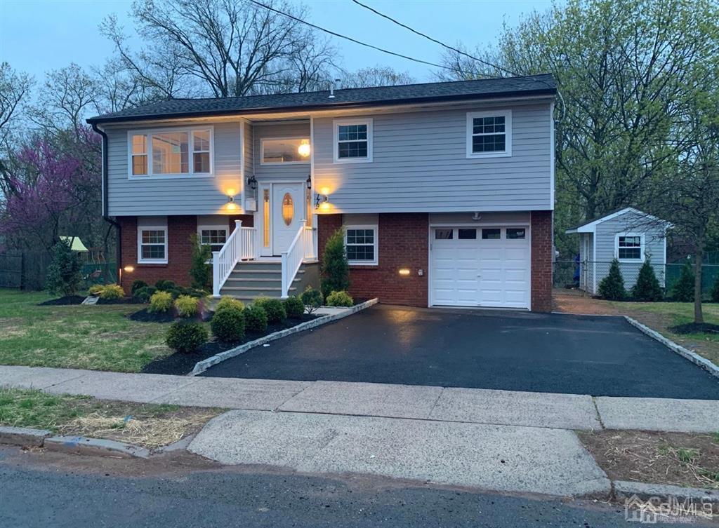 179 Phillips Road Somerset, NJ 08873 - Photo 2 of 26 a front view of a house with a yard and garage