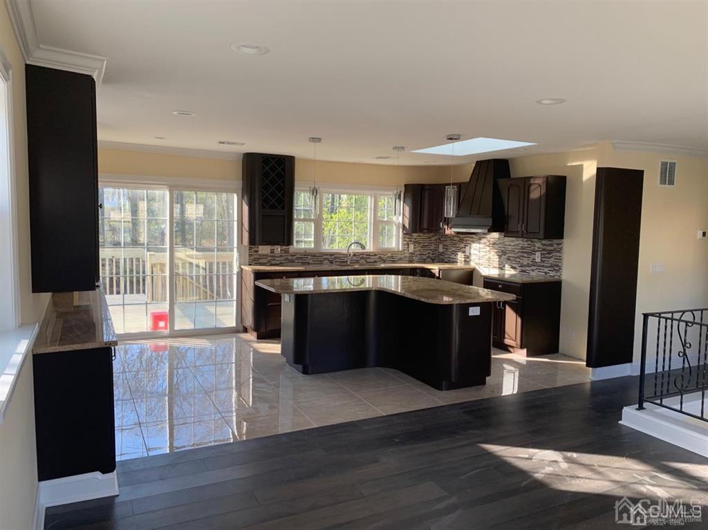 179 Phillips Road Somerset, NJ 08873 - Photo 7 of 26 a kitchen with stainless steel appliances granite countertop a stove a sink and a microwave