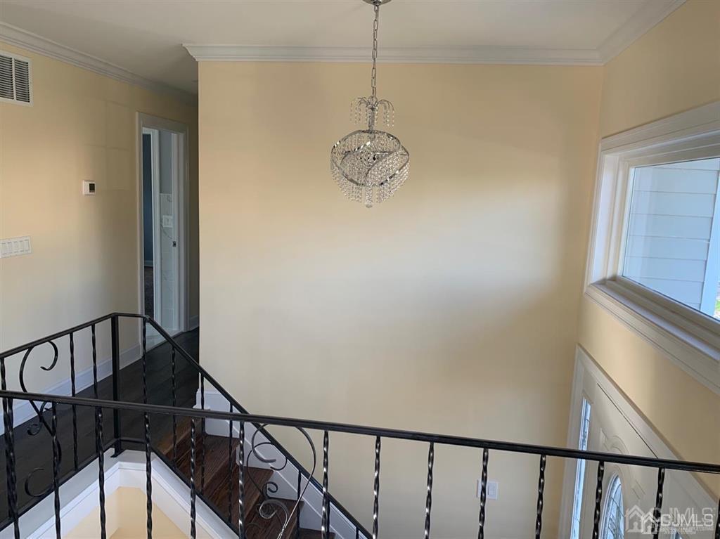 179 Phillips Road Somerset, NJ 08873 - Photo 10 of 26 a view of a hallway with wooden floor and stairs