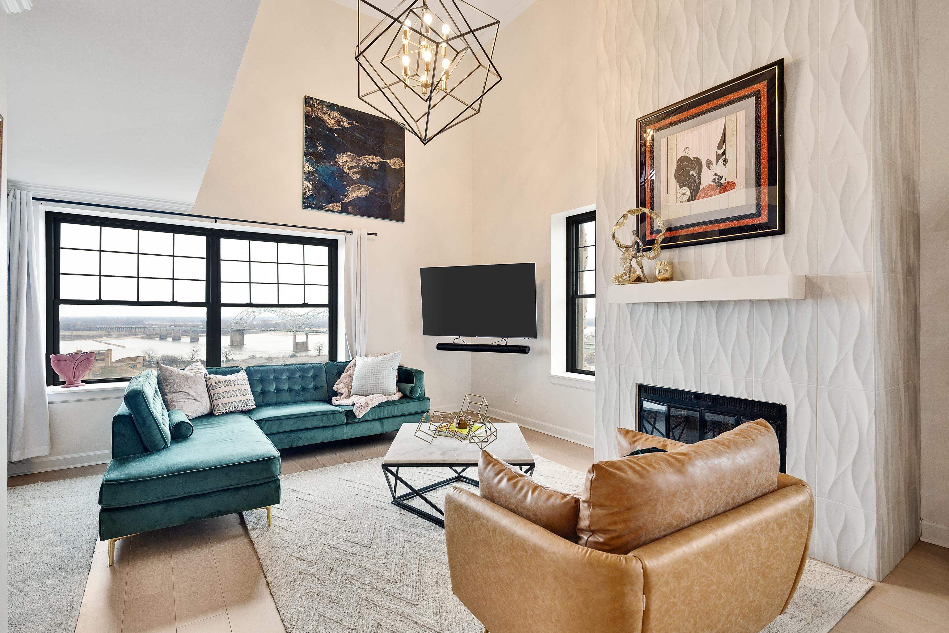 109 North Main Street, Unit 1610 Memphis, TN 38103 - Photo 28 of 35 a living room with furniture a flat screen tv and a fireplace