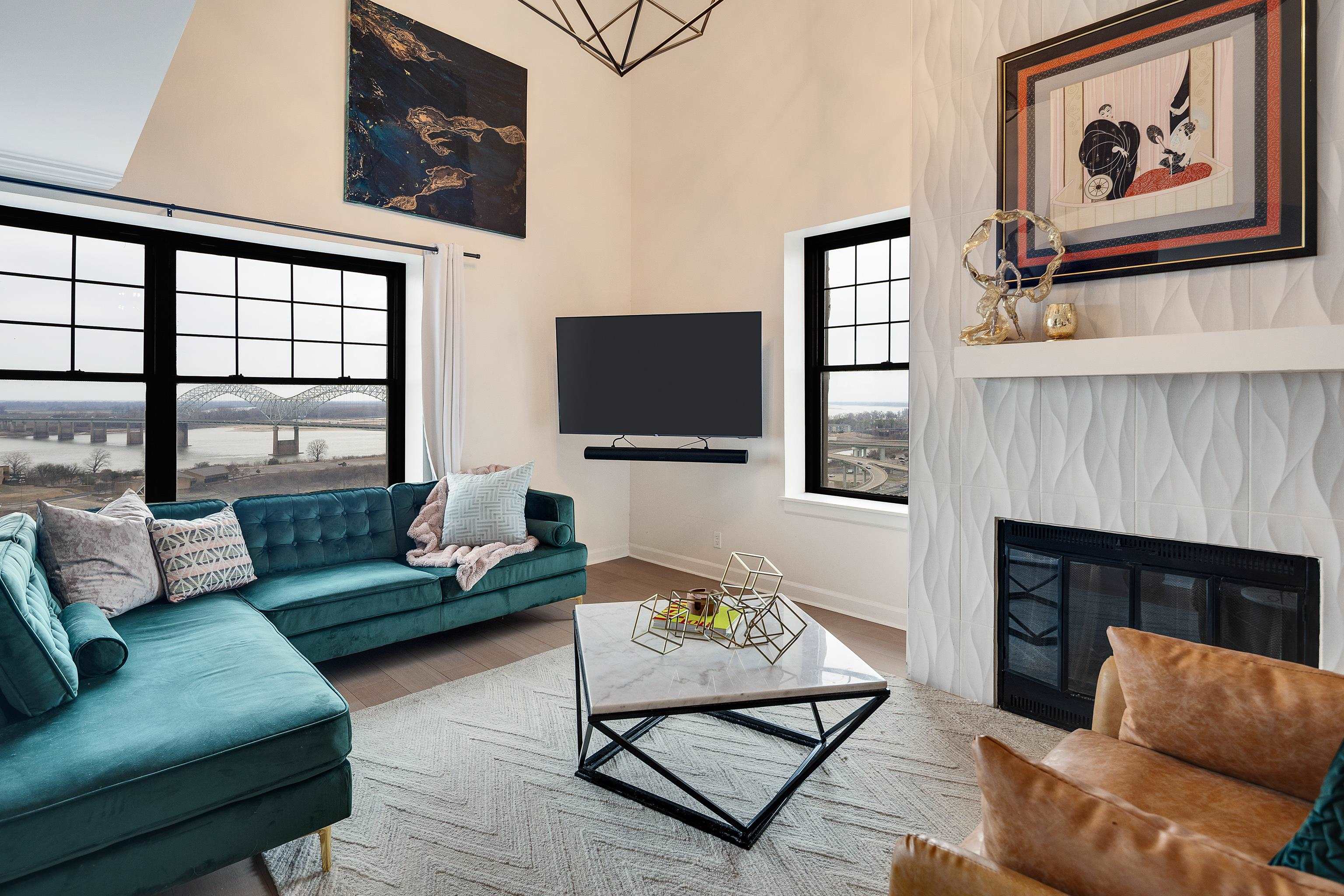 109 North Main Street, Unit 1610 Memphis, TN 38103 - Photo 33 of 35 a living room with furniture a flat screen tv and a fireplace