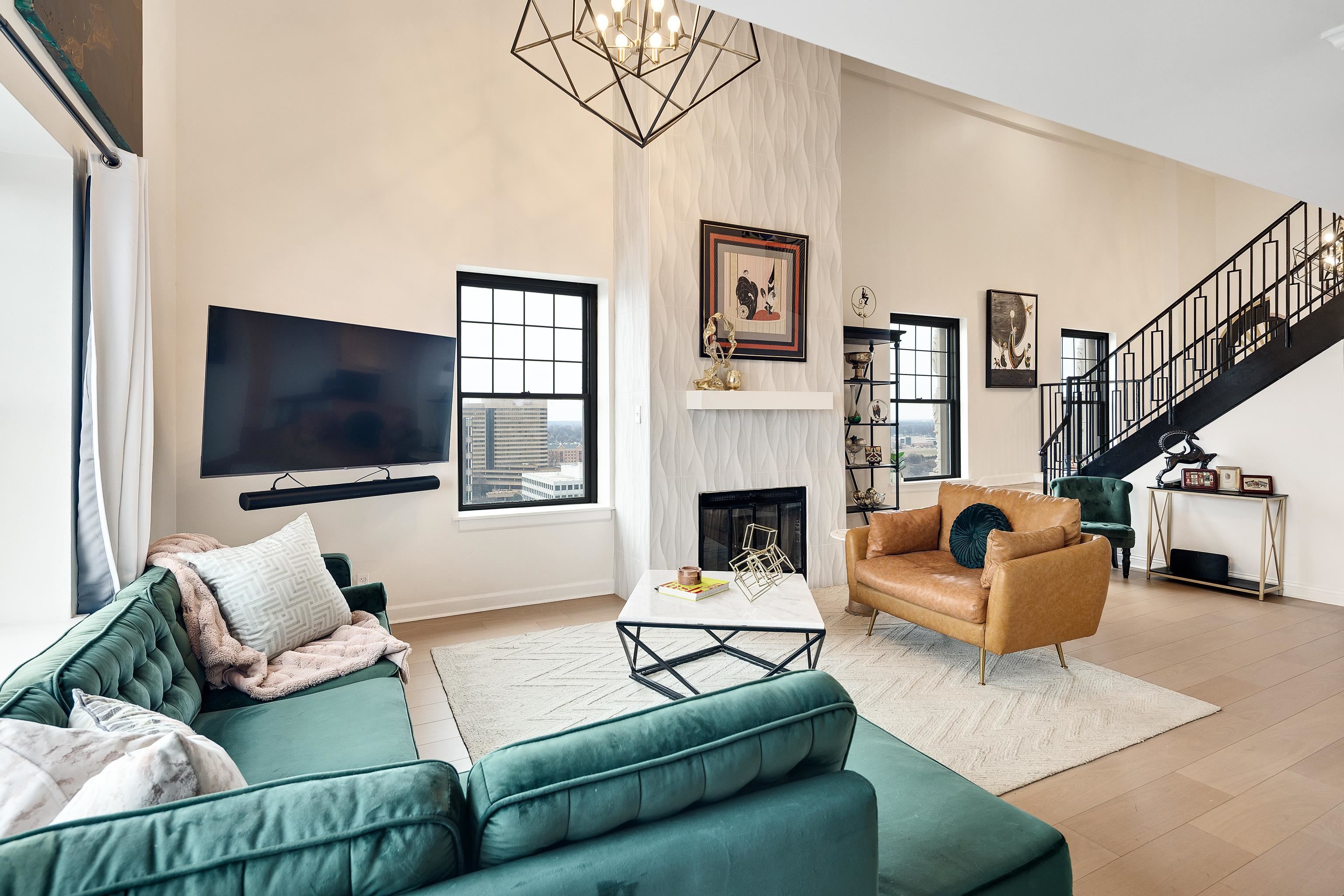 109 North Main Street, Unit 1610 Memphis, TN 38103 - Photo 34 of 35 a living room with furniture a flat screen tv and a fireplace