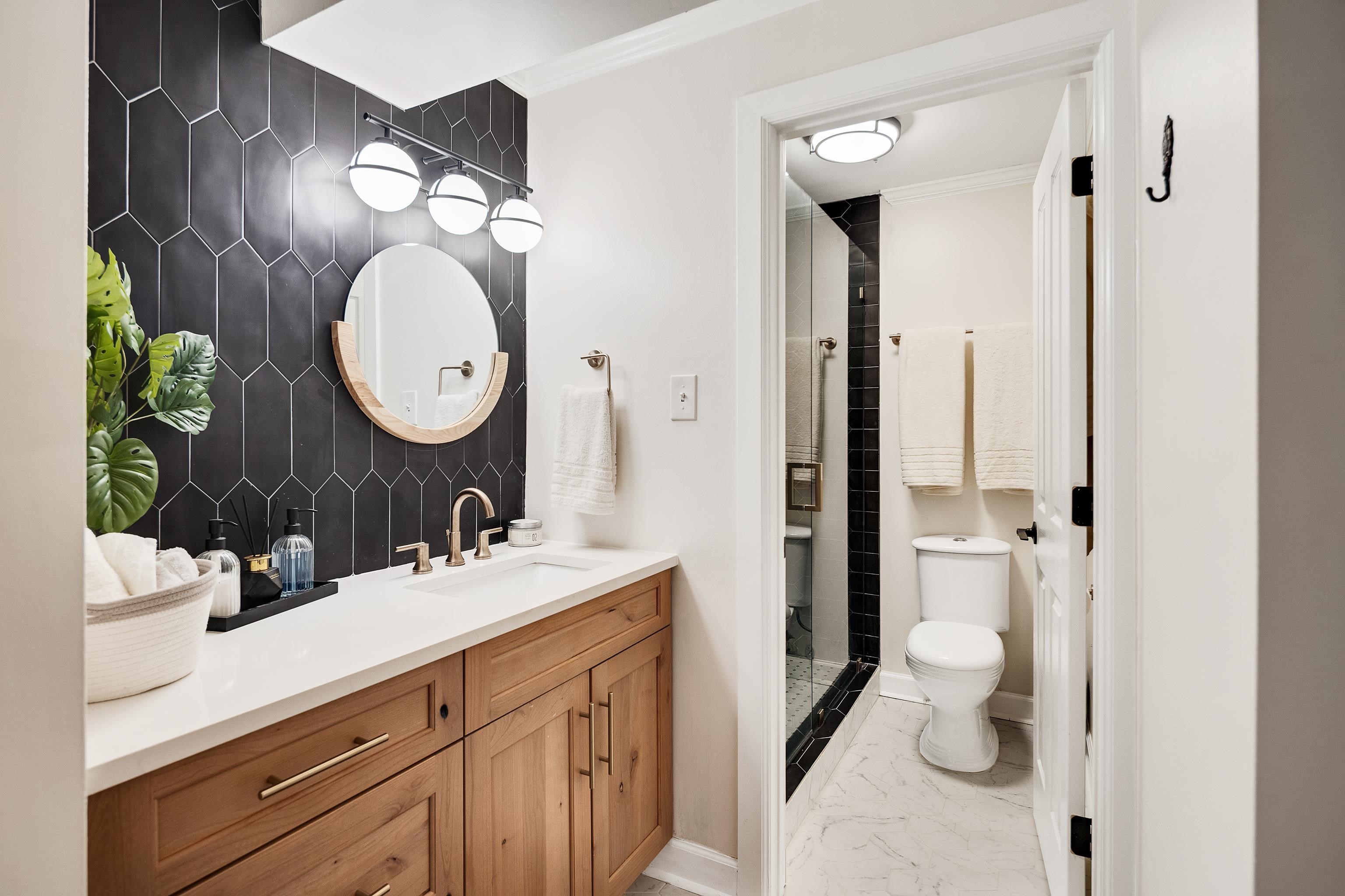 109 North Main Street, Unit 1610 Memphis, TN 38103 - Photo 8 of 35 a bathroom with a double vanity sink mirror and shower