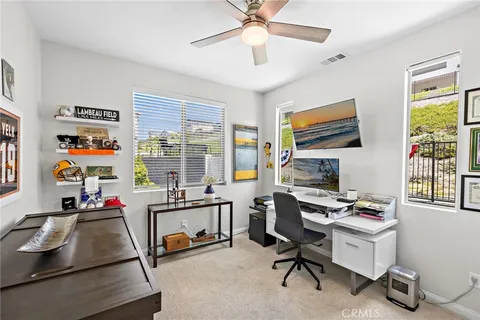 a room with furniture a flat screen tv and a window