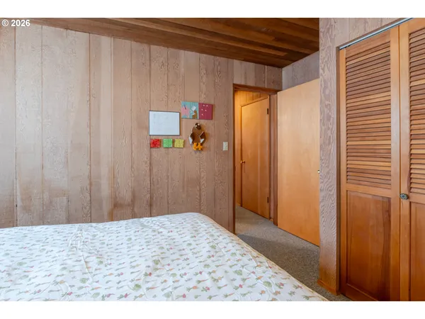 a view of a bedroom with a bed and a window