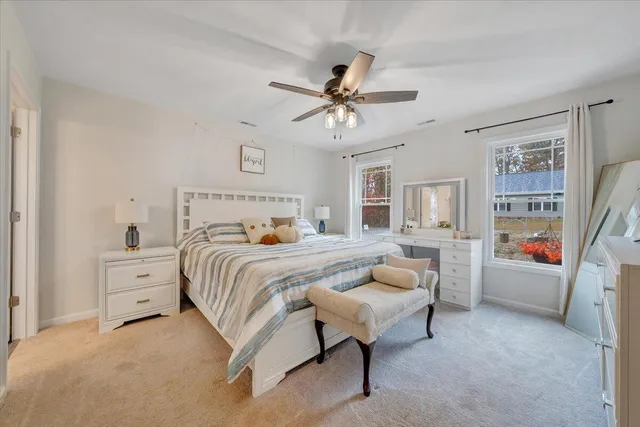 a open kitchen with white cabinets and wooden floor