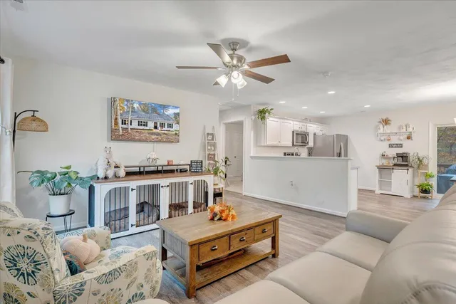 a living room with furniture and kitchen view