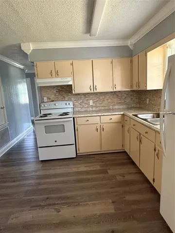 a kitchen with a sink stove and cabinets
