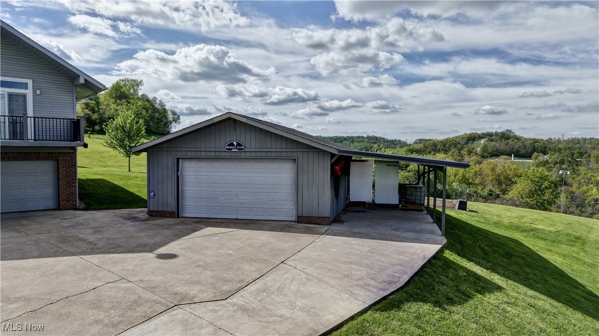 85530 Beagle Club Road Scio, OH 43988 - Photo 10 of 49 View of front of property with a front yard, a garage, and an outdoor structure