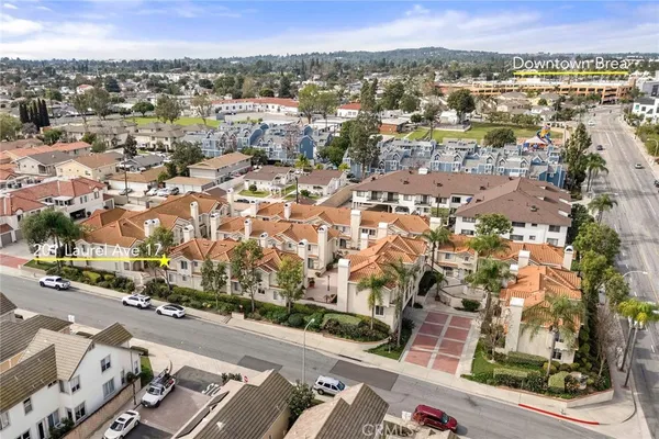 an aerial view of residential building with green space