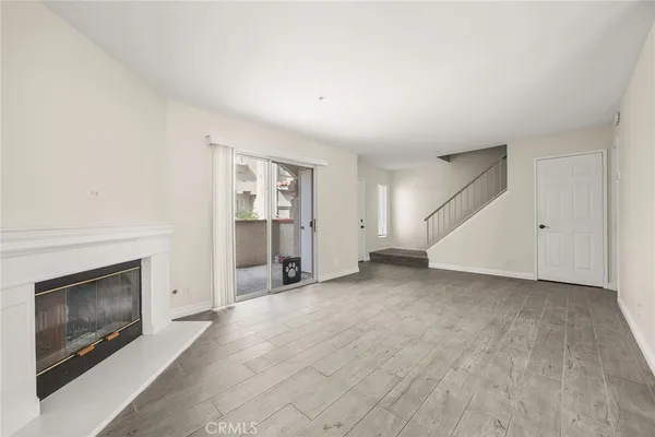 an empty room with a fireplace and window