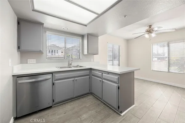 a kitchen with granite countertop cabinets sink and window