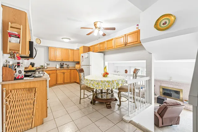 a kitchen with stainless steel appliances kitchen island granite countertop a sink dishwasher and cabinets with wooden floor