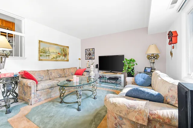 a view of a livingroom with furniture and a large window