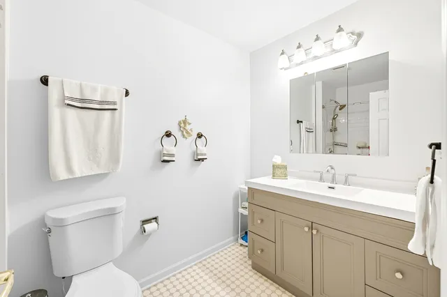 a bathroom with a shower toilet and sink