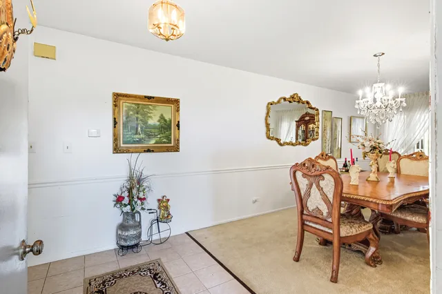 a view of a dining room with furniture and a chandelier