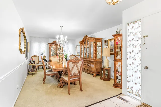 a view of a dining room with furniture and chandelier
