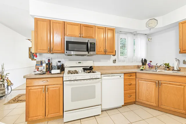 a kitchen with stainless steel appliances a refrigerator and a stove top oven