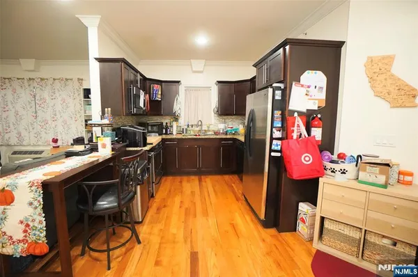 a kitchen that has a lot of cabinets and appliances