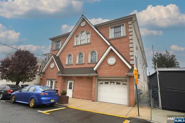 a front view of a house with parking