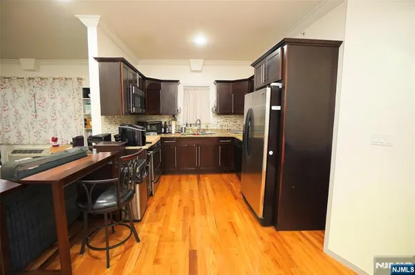 a kitchen with a sink appliances and cabinets