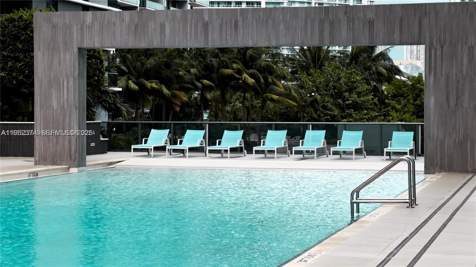 55 Southwest 9th Street, Unit 2305 Miami, FL 33130 - Photo 18 of 23 a view of swimming pool with seating space and garden view