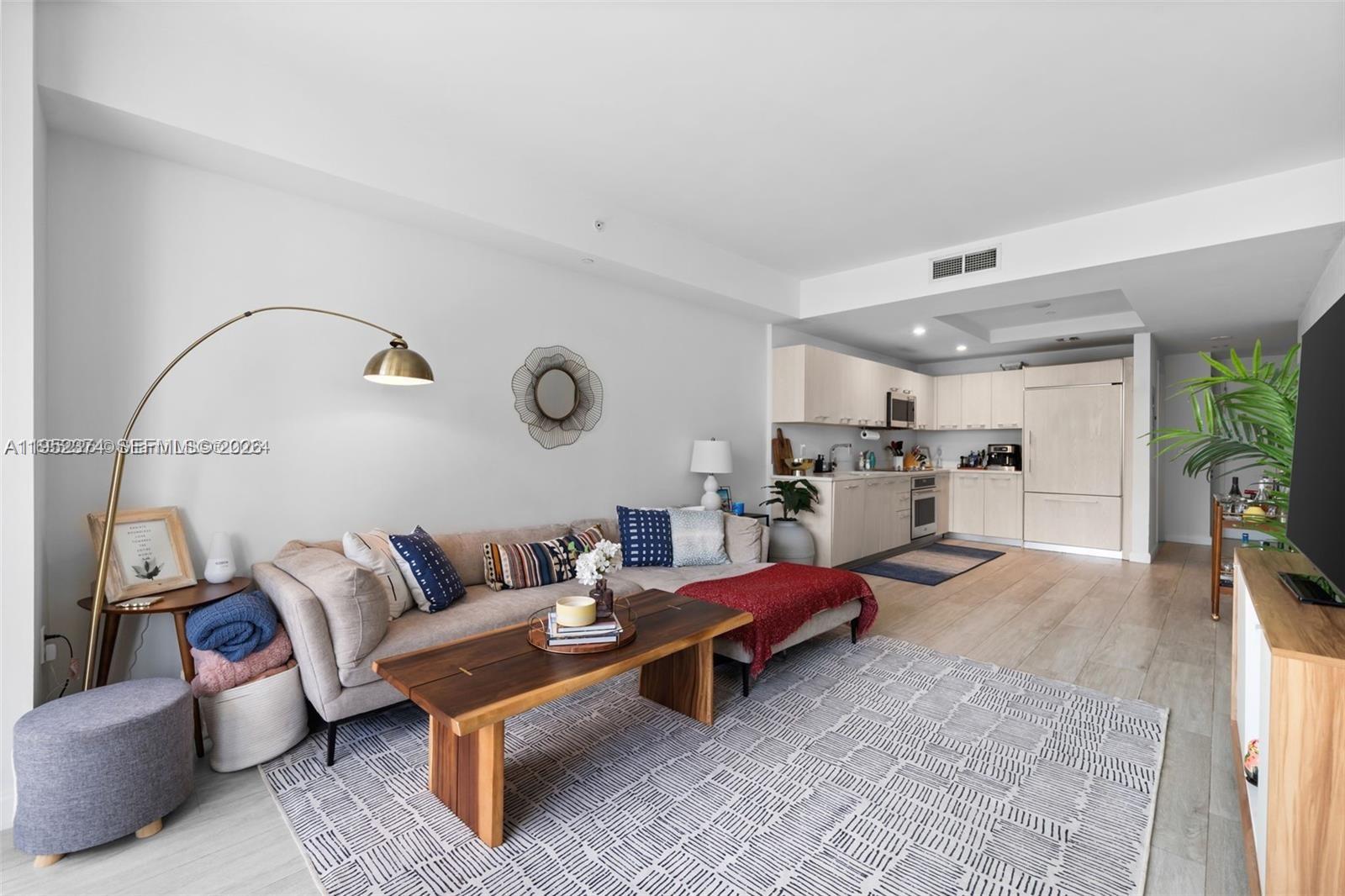 55 Southwest 9th Street, Unit 2305 Miami, FL 33130 - Photo 4 of 23 a living room with furniture and view of kitchen