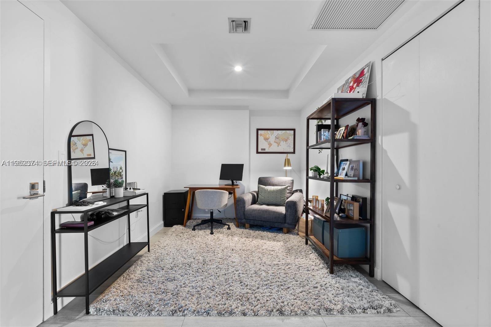 55 Southwest 9th Street, Unit 2305 Miami, FL 33130 - Photo 8 of 23 a living room with furniture or couch and a dresser