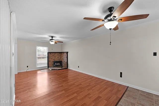 a view of an empty room with a fireplace