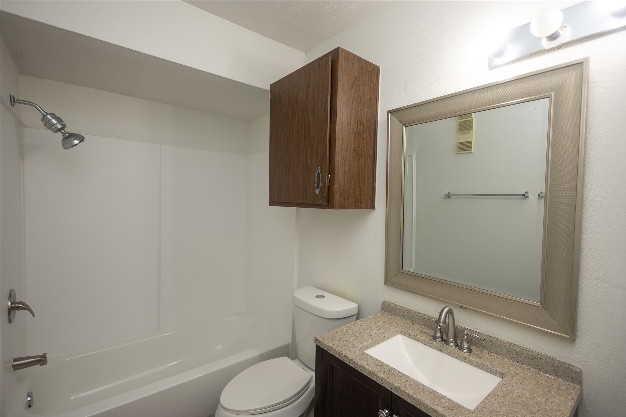 8100 Cambridge Street, Unit 89 Houston, TX 77054 - Photo 20 of 41 Downstairs secondary bathroom with a tub/shower combo and single-sink vanity.