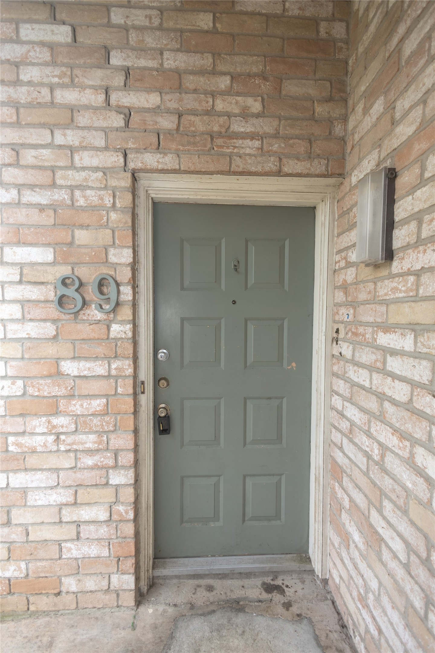 8100 Cambridge Street, Unit 89 Houston, TX 77054 - Photo 2 of 41 Front entry of this 2-bedroom, 2-bath condo, featuring a brick exterior and a covered doorway.