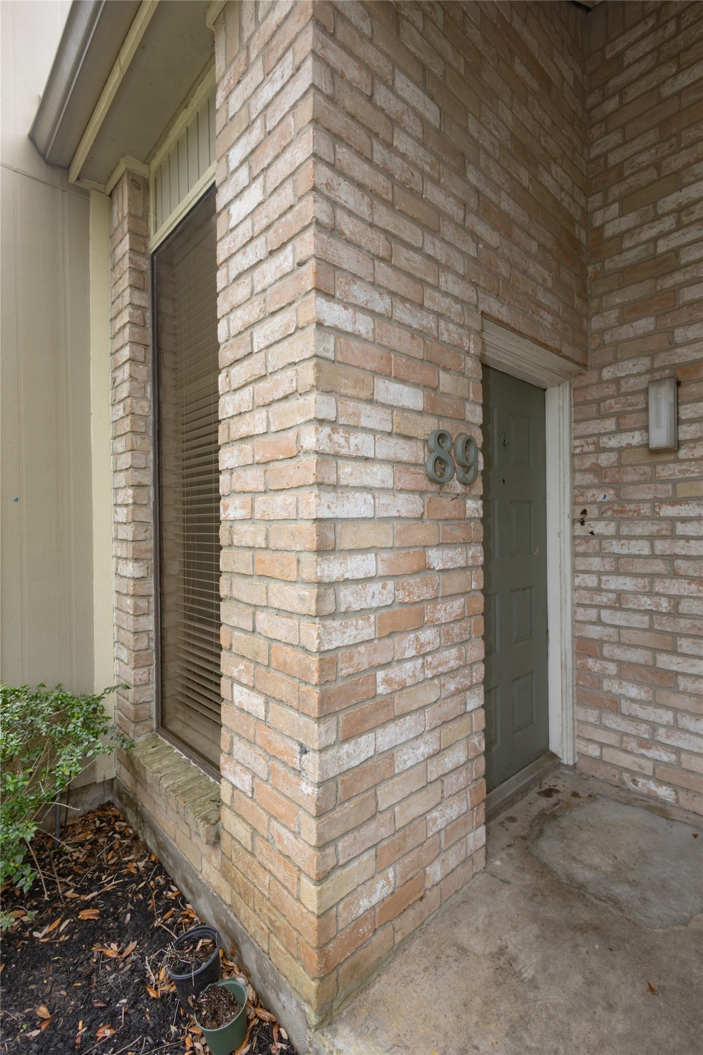8100 Cambridge Street, Unit 89 Houston, TX 77054 - Photo 3 of 41 Front entry of this 2-bedroom, 2-bath condo, featuring a brick exterior and a covered doorway.