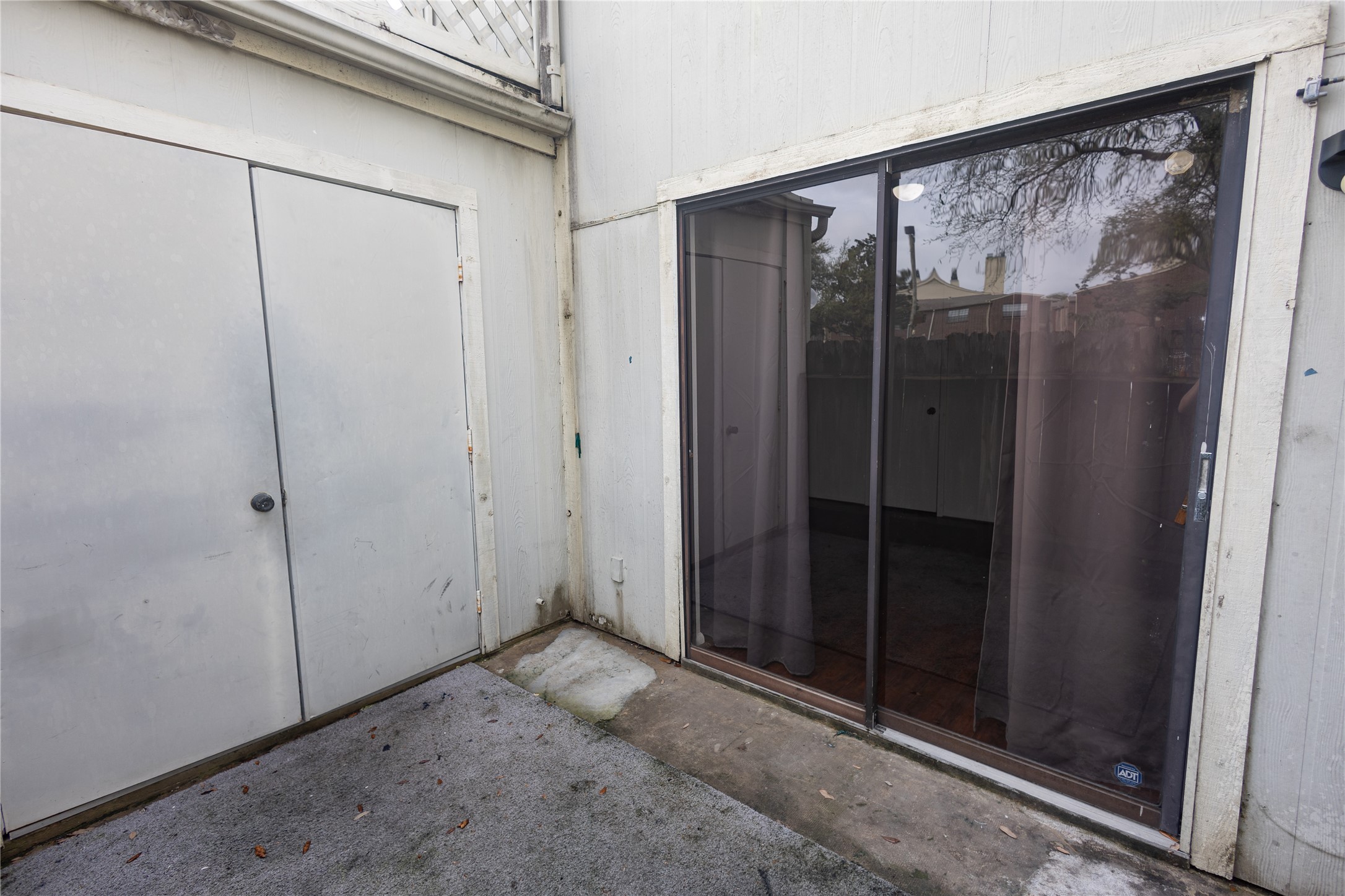 8100 Cambridge Street, Unit 89 Houston, TX 77054 - Photo 40 of 41 Photo features the private patio area. Sliding door leads to the secondary bedroom while the double doors hold the washer and dryer.