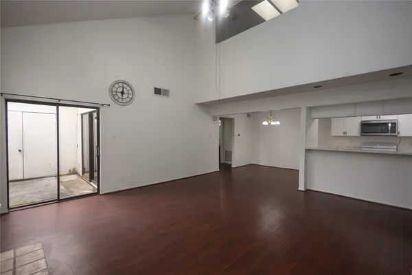 a view of a kitchen with wooden floor and a window