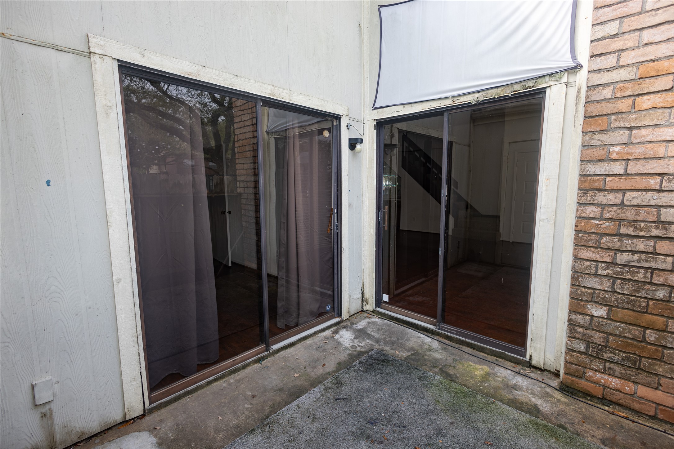 8100 Cambridge Street, Unit 89 Houston, TX 77054 - Photo 41 of 41 Alternate view of the patio area showcasing the sliding doors that lead into the living area and the secondary bedroom.
