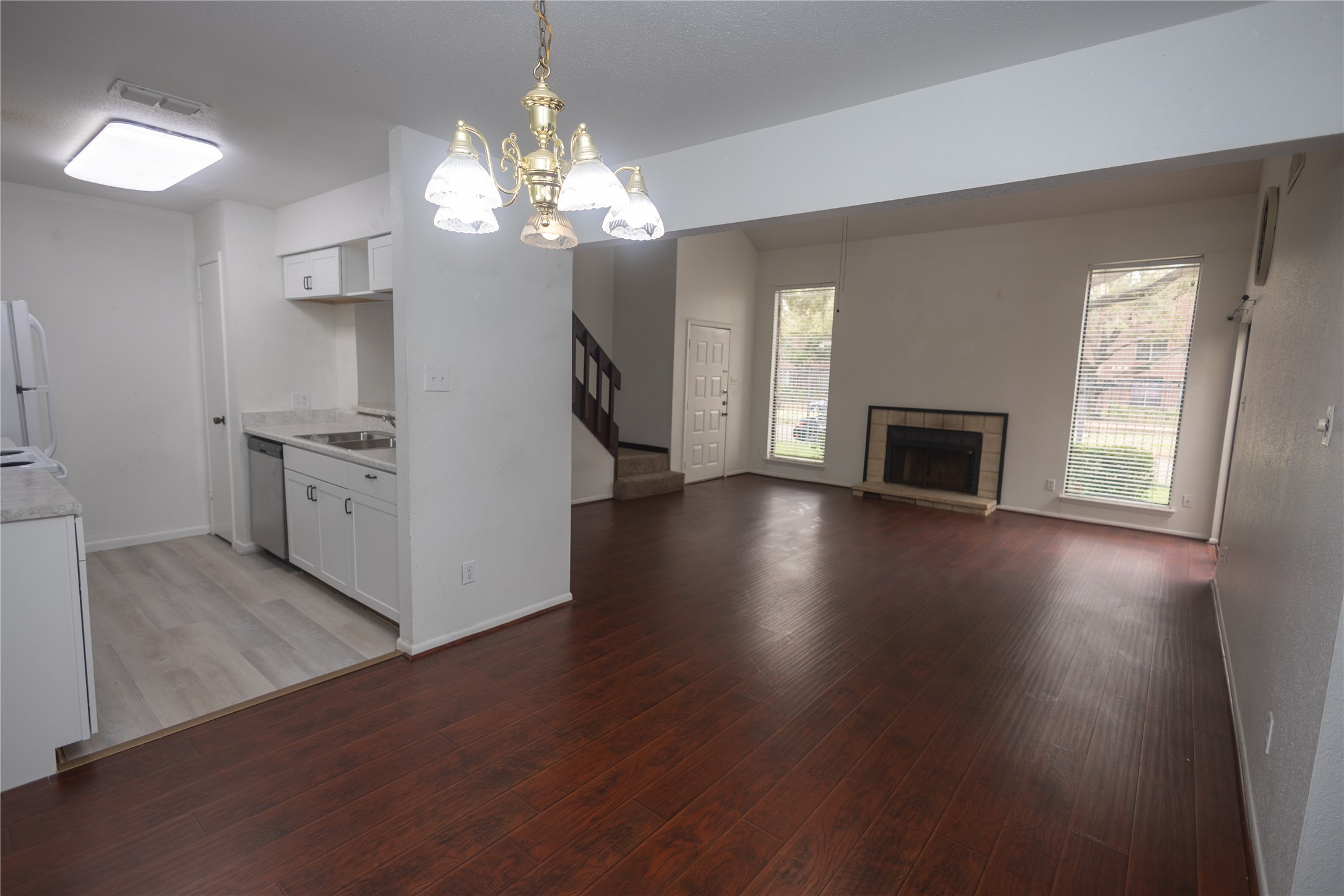 8100 Cambridge Street, Unit 89 Houston, TX 77054 - Photo 10 of 41 Open layout with updated kitchen, dedicated dining area, and a spacious living room featuring a fireplace and tall windows.